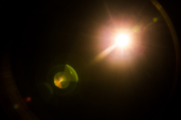 abstract lens flare red light over black background