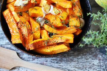 Baked pumpkin slices in a pan. Autumn food. Keto friendly.