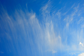 against a clear, delicate, blue sky rare stains of white clouds