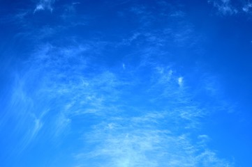 against a clear, delicate, blue sky rare stains of white clouds