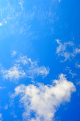 against a clear, delicate, blue sky rare stains of white clouds