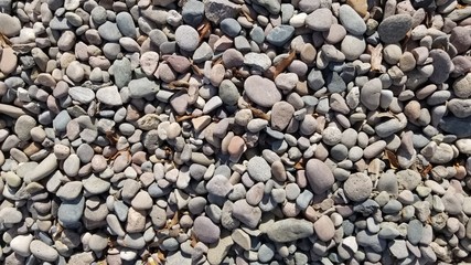 Gray pebbles on the beach for background