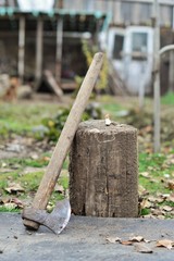 old rusty axe in a tree stump