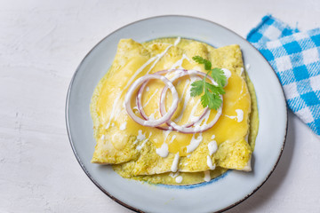 Mexican green enchiladas with melted cheese also called 