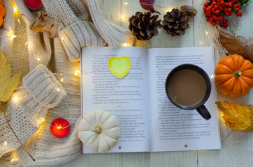 Autumn still life with pumpkins, book,coffee,leaves and pinecone