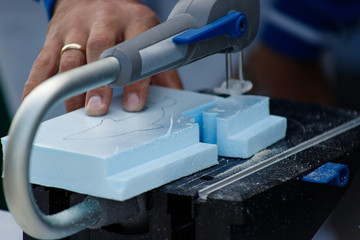 Hands of a male carpenter making a workpiece on a joiner's machine