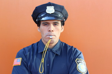 Obraz premium Ethnic American cop blowing a whistle 