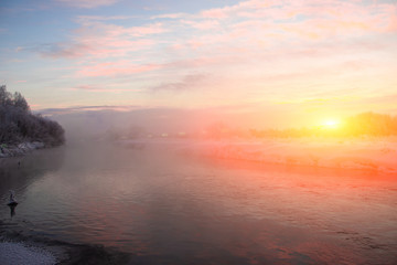 Morning dawn on the river in winter frost. Winter landscape. Morning m on the river. Severe frost. Evaporation from water.