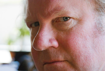 Older Mans Face Looking Hurt, Angry and Suspicious