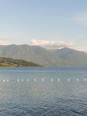 Serene panorama of the calm waters of Panguipulli Lake, from the village of Panguipulli. Patagonian area, Chile.