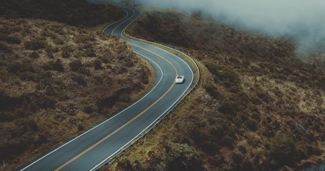 Aerial view following a vintage white convertible