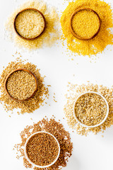 Healthy food. Cereals - rice, oats, buckwheat - in bowls on white background top view