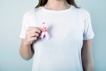 young woman checking her breast for breast cancer