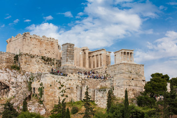 Fototapeta na wymiar Tourists visiting the Acropolis in a beautiful early spring day seen from the Areopagus Hill in Athens