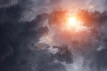 Obraz premium Epic dramatic storm dark grey clouds with sun and sunlight 