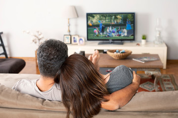 couple watching tv in living room