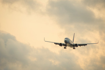 Silhouette of a passenger airliner in the sky during sunset. Airplane in the sky.