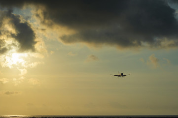 Silhouette of a passenger airliner in the sky during sunset. Airplane in the sky.