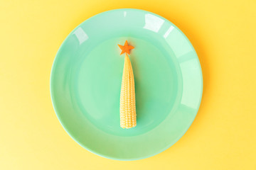 Funny edible Christmas tree from baby corn and carrot. Beautiful New Year meal creative...