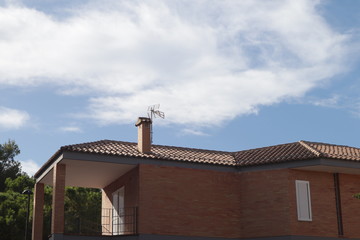 A residential house with an antenna on the roof