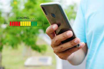Loading 2020 with young man using a smartphone