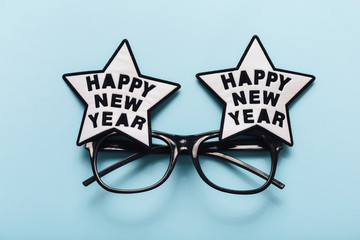 happy new year glasses on blue background, top view