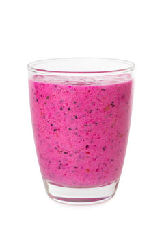 Vertical image of glass of red dragon fruit with coconut milk super food smoothie isolated at white background. Concept of healthy vegan lifestyle.