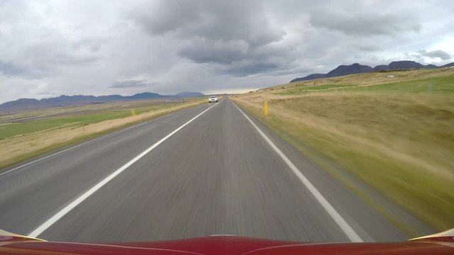 POV driving past police car under storm clouds Icelandic countryside.mov