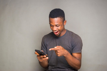 young adult man feels happywith he saw on his phone