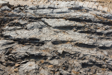 Potholes on the dirt road closeup