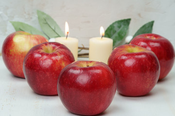 Red apples with candles and leaves.