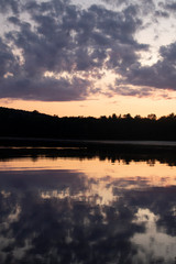 Fototapeta na wymiar Sunset on The Lake in Vermont. Beautiful nature retreat. Sunset reflected in the water. Calming and relaxing escape.