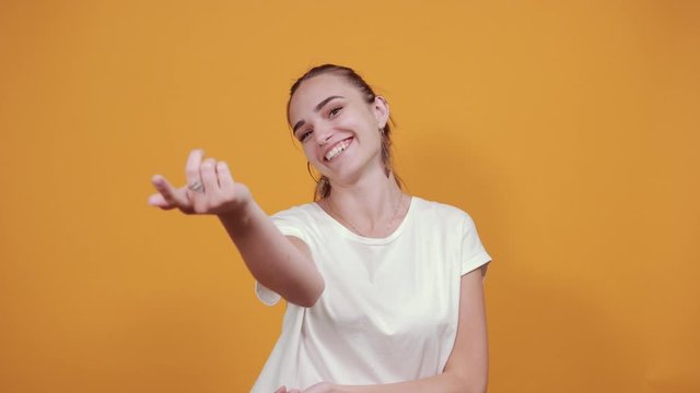 Girl frankly talking to friends. She is laughing and pointing to one of her good friends like in a friends conversation.