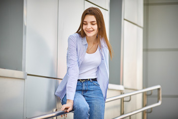 young girl stands near the building. Copy space.