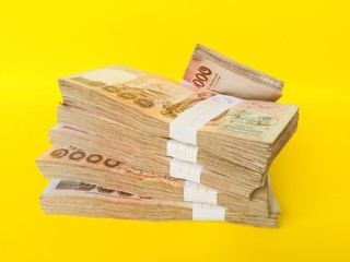 Thai bank note stack scene isolated on a yellow background