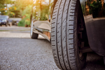 Car parked on street,Car on road and sunset background,Tire of car on road