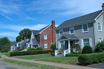 Suburban street with older brick and clapboard houses