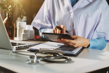 Medical technology concept. Doctor working with mobile phone and stethoscope and digital tablet...