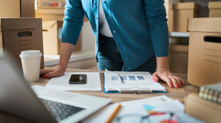 Woman is working at warehouse for online store.