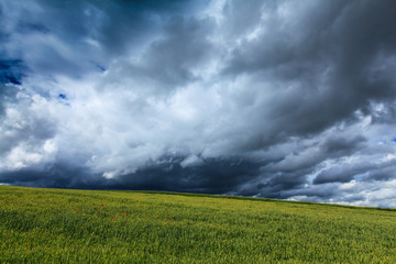 Fototapeta na wymiar Beautiful summer fields and storm clouds in a remote rural area in Europe