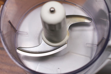 Food processor blender or coffee grinder close up of blades on wooden table