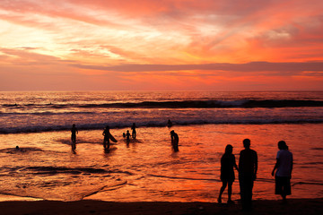 Swimming insunset on Montanita beach on the Pacific coast of Ecuador