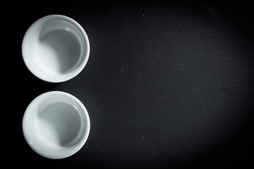 Two empty white ceramic crockery