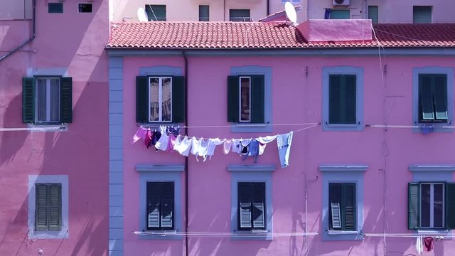 Stretched cloathes on a pink house in Italy