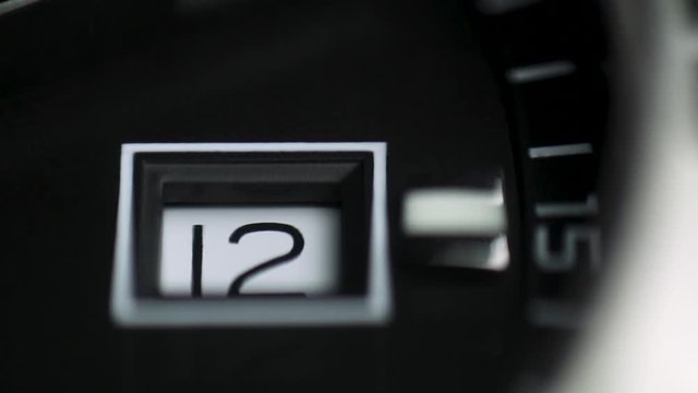 Close up watch face. Silver clock hand ticks.