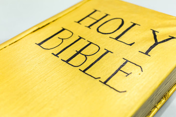 golden color holy bible cover closeup detail view
