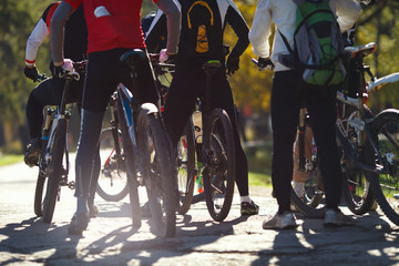 Group of athletes before the start of the cycling competition, back view. Face is not visible.