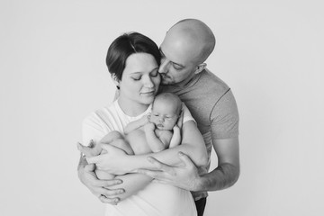 family photo on a white background: parents spend time with their children. mom and dad hug the baby. the concept of childhood, fatherhood, motherhood, IVF