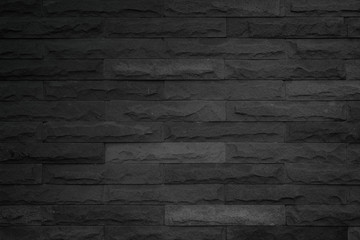 Wall dark black brick texture background. Brickwork or stonework flooring interior backdrop grunge...
