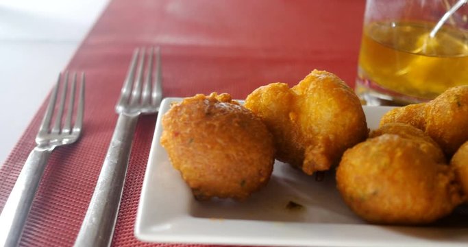 Accras de Morue, healthy fritter Caribbean food. salt fish based gastronomy, these cod balls appetizer cooked in oil are beautiful and delicious holiday meal in restaurant.